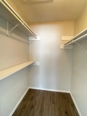 a view of a room with wooden floor