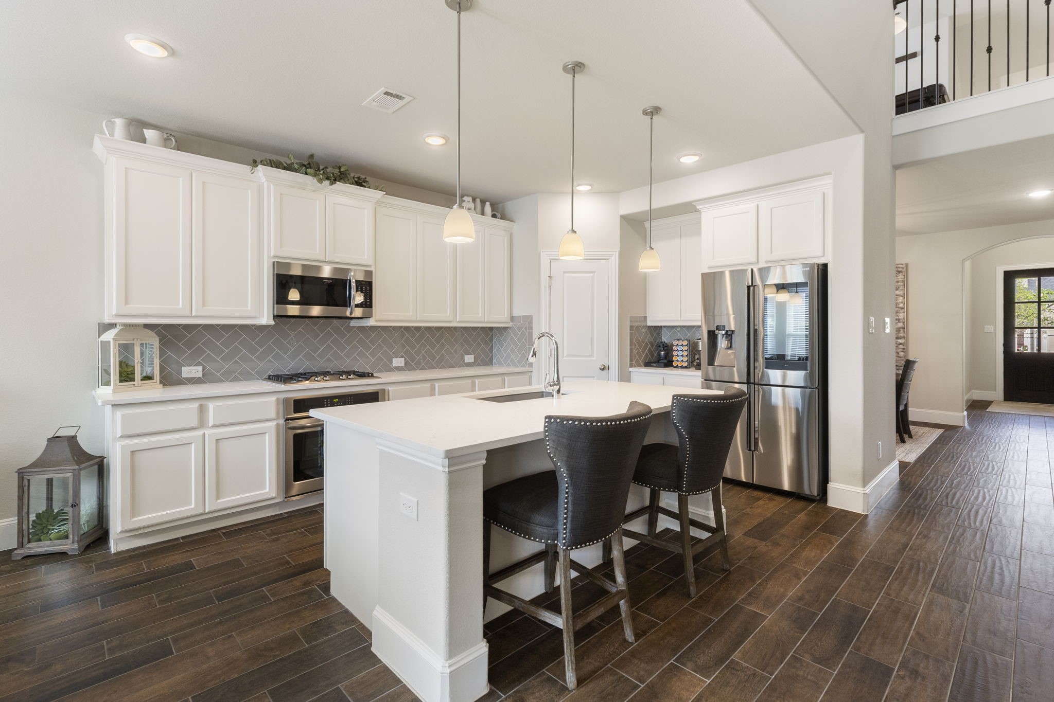 1030 Bat Hawk Court Conroe, TX 77385 - Photo 16 of 47 a kitchen with kitchen island granite countertop a sink a counter space stainless steel appliances and cabinets