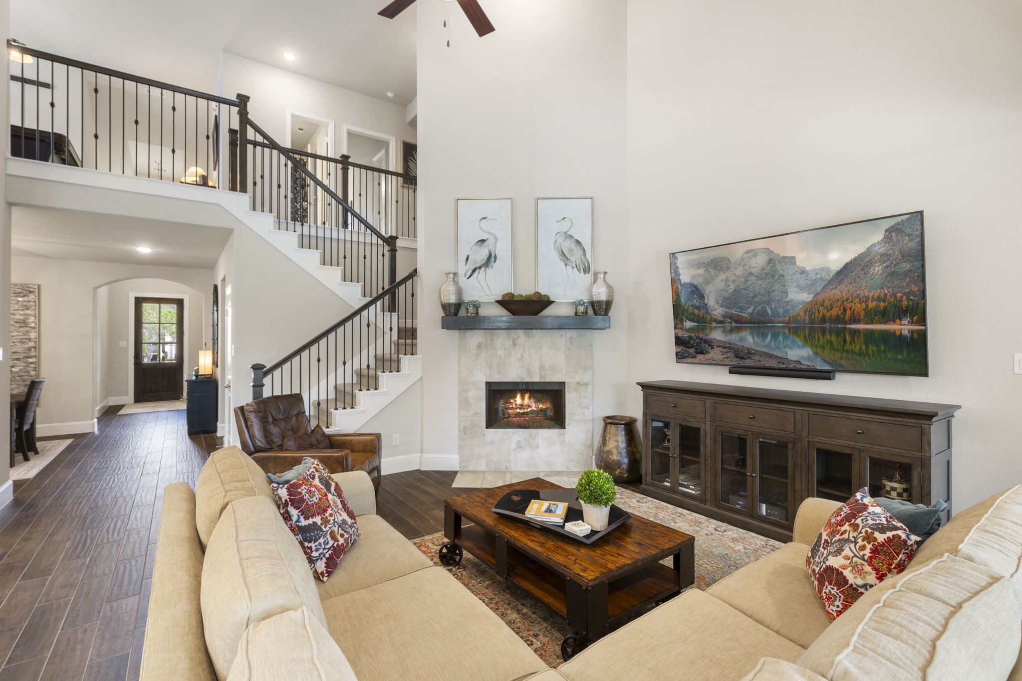 1030 Bat Hawk Court Conroe, TX 77385 - Photo 2 of 47 a living room with furniture a fireplace and a flat screen tv