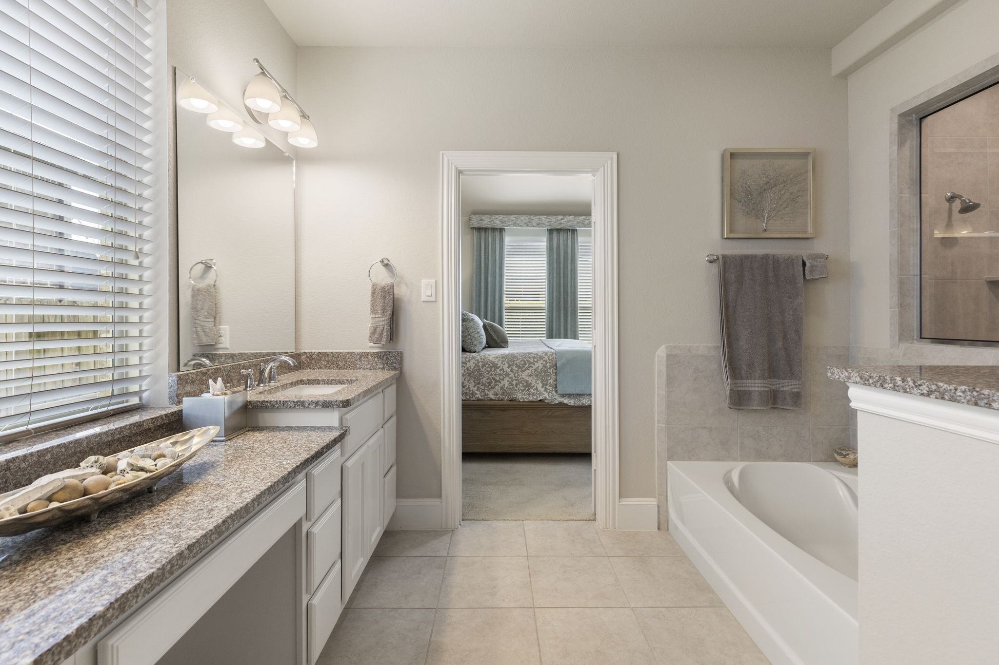 1030 Bat Hawk Court Conroe, TX 77385 - Photo 30 of 47 a en suite bathroom with a granite countertop tub sink and mirror