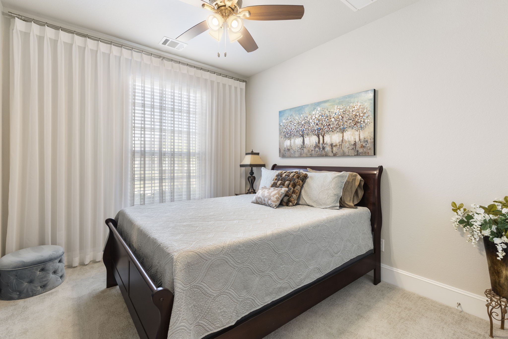 1030 Bat Hawk Court Conroe, TX 77385 - Photo 36 of 47 a bedroom with a large bed and a chandelier
