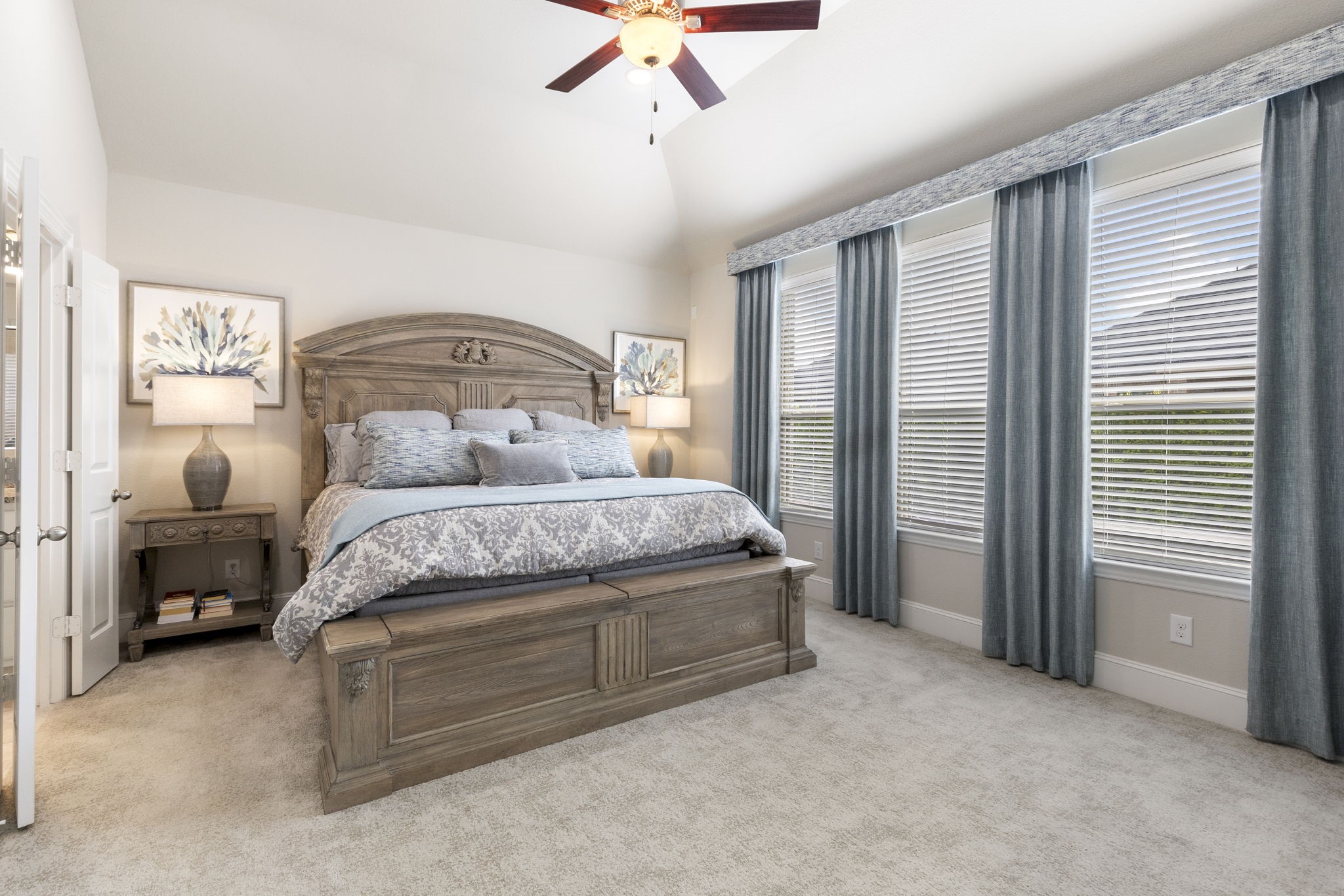 1030 Bat Hawk Court Conroe, TX 77385 - Photo 4 of 47 a bedroom with a large bed and a chandelier fan