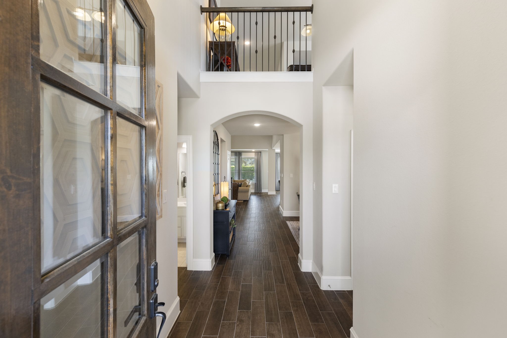 1030 Bat Hawk Court Conroe, TX 77385 - Photo 10 of 47 a view of a hallway with wooden floor and staircase