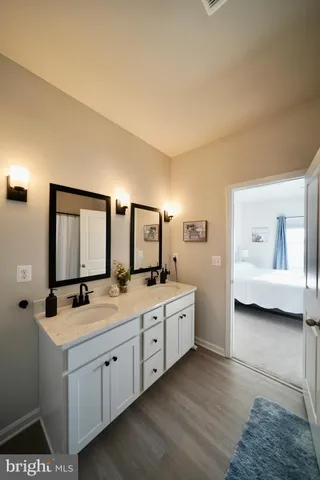 a view of a hallway view with living room and wooden floor