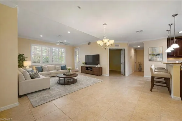 a living room with furniture and a chandelier