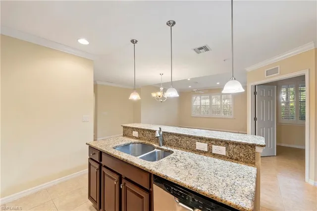 a kitchen with a sink a counter space and wooden floor