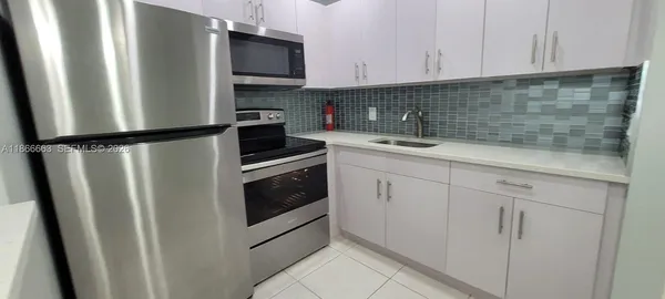 a kitchen with stainless steel appliances a stove a microwave and a refrigerator