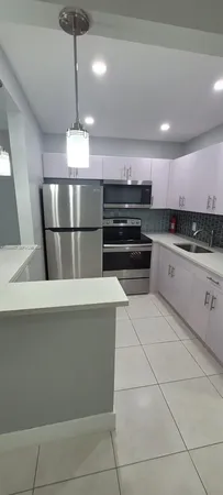 a view of a hallway to rooms and stairs