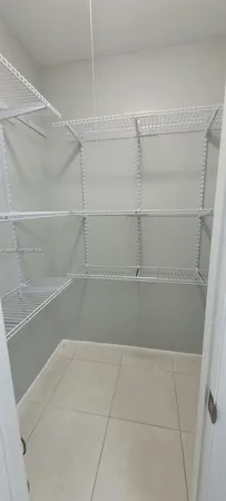 a view of an empty room with a fan