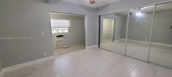 a view of an empty room with a mirror