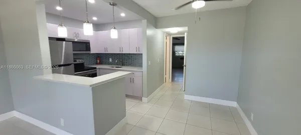 a kitchen with a sink cabinets and stainless steel appliances