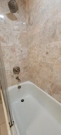a bathroom with a shower and a tub
