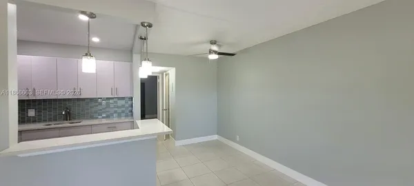 en empty room with wooden floor and mirror