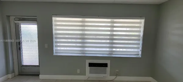 a kitchen with a refrigerator sink and cabinets