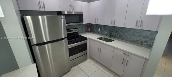 a kitchen with a refrigerator stove and sink