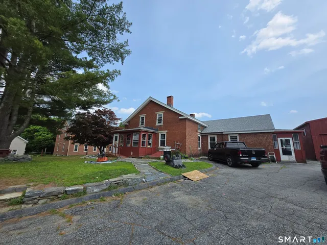 a car parked in front of white house