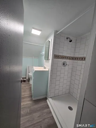 a bathroom with a sink a mirror and shower