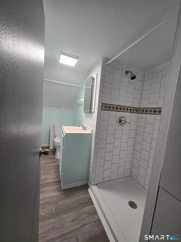 a bathroom with a sink a mirror and shower