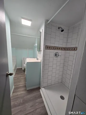 a bathroom with a sink a toilet and shower