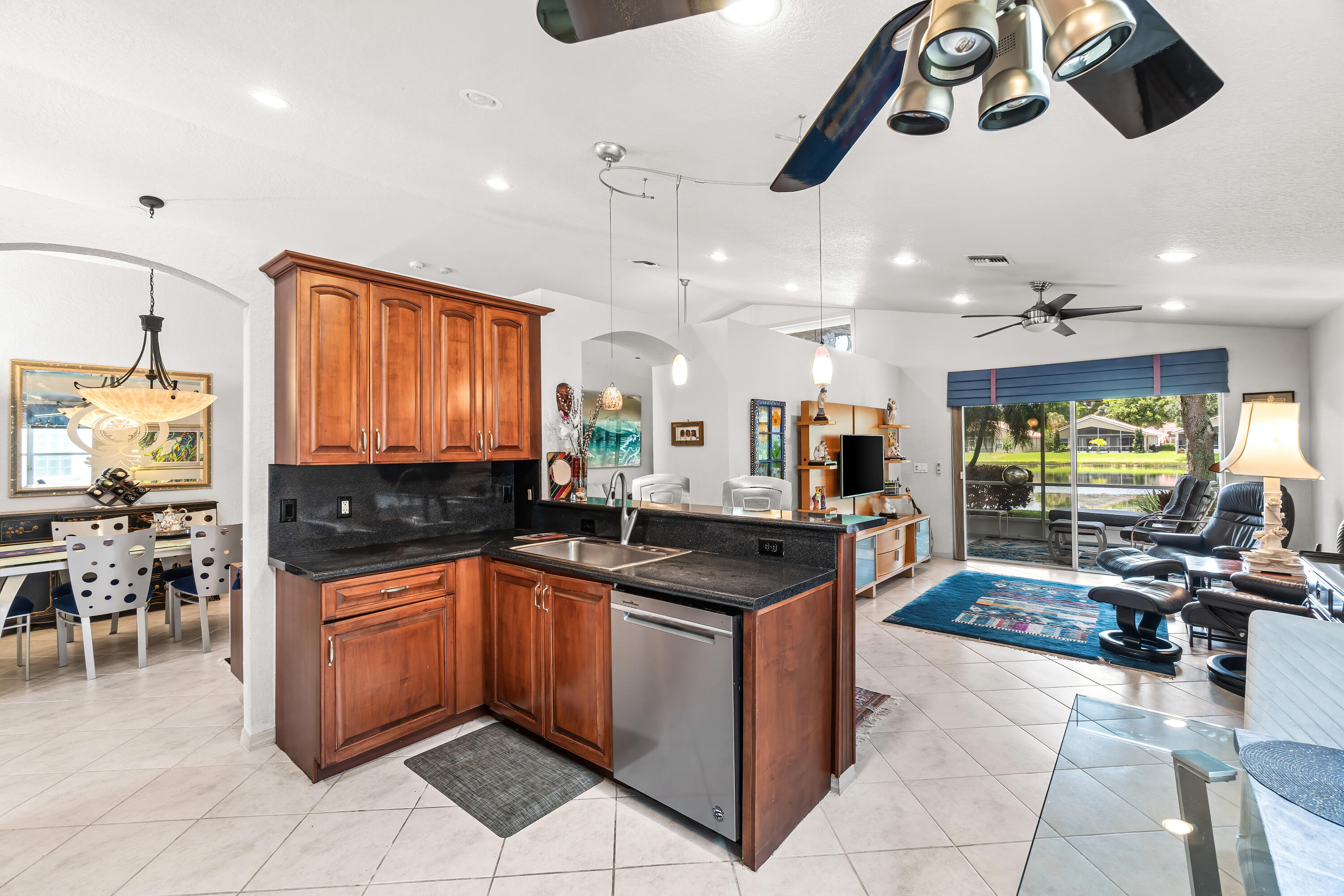 7370 Modena Drive Boynton Beach, FL 33437 - Photo 15 of 37 a kitchen with stainless steel appliances granite countertop a sink and cabinets