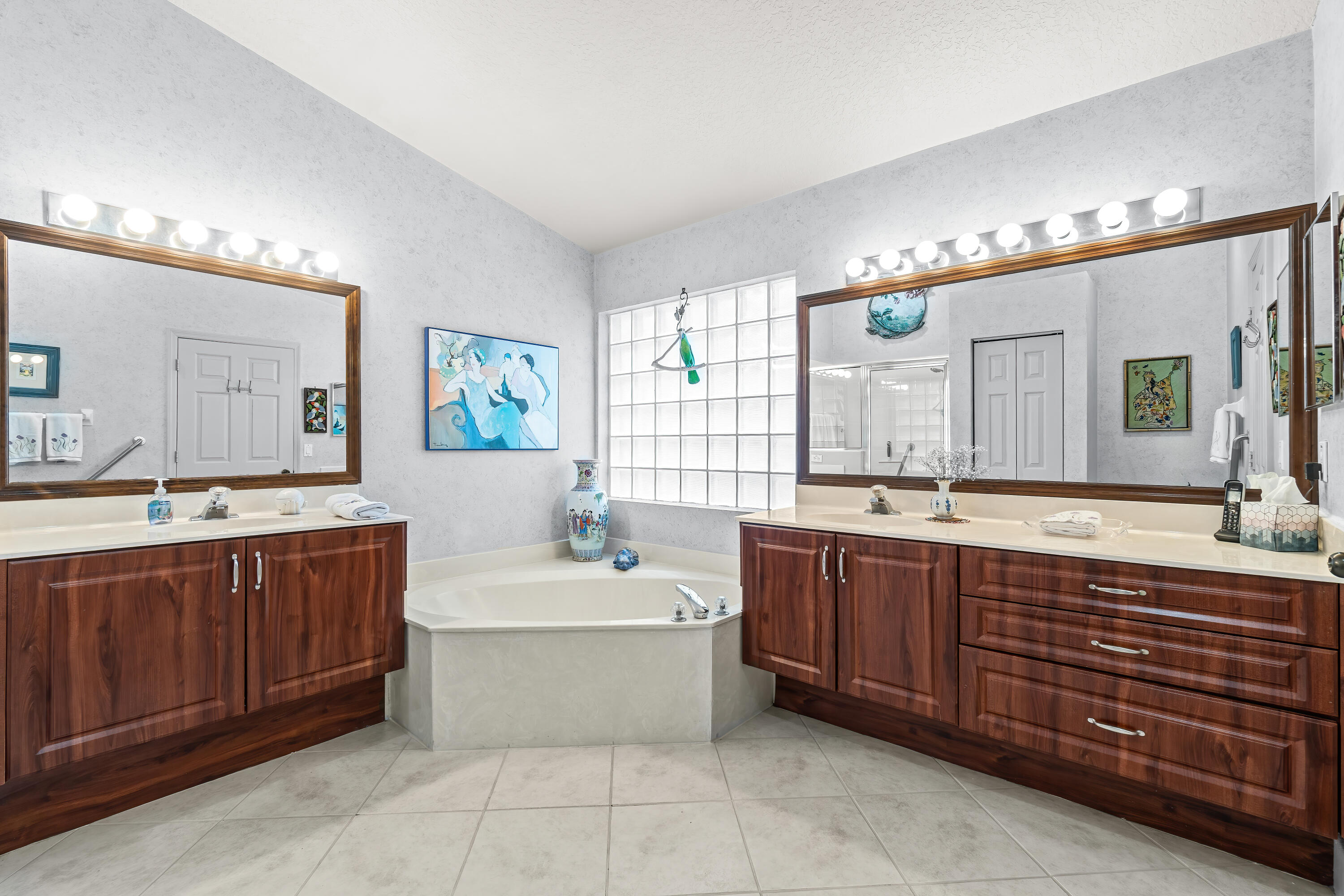 7370 Modena Drive Boynton Beach, FL 33437 - Photo 24 of 37 a spacious bathroom with a double vanity sink large mirror and a bathtub