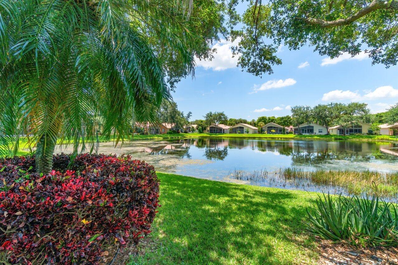 7370 Modena Drive Boynton Beach, FL 33437 - Photo 31 of 37 a view of a lake with a house in background