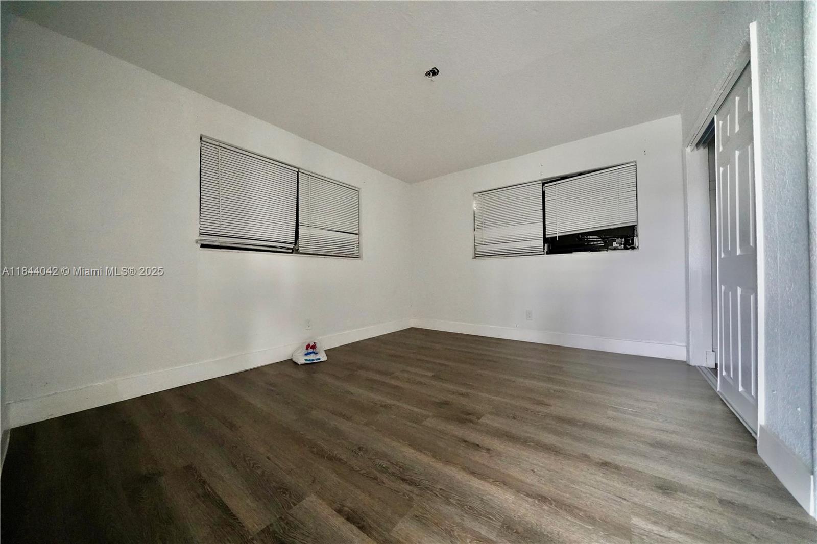 3376 Northwest 49th Street, Unit B Miami, FL 33142 - Photo 9 of 14 a view of empty room with wooden floor