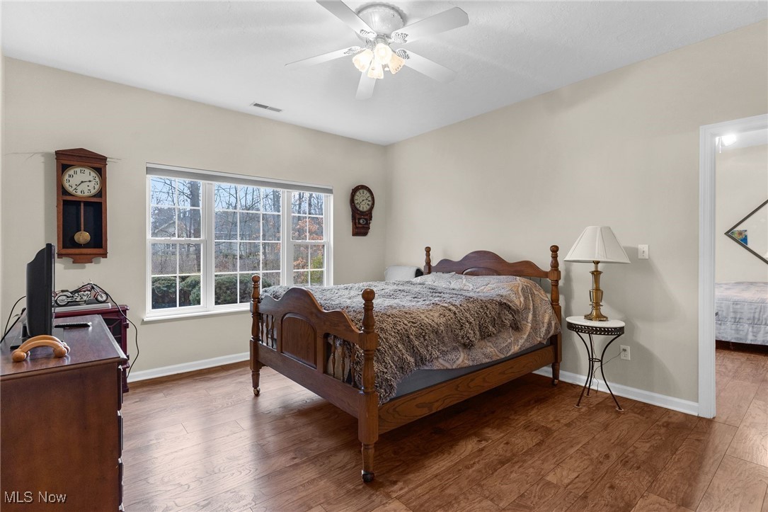 142 Wilcox Road Youngstown, OH 44515 - Photo 18 of 36 Bedroom featuring a ceiling fan, visible vents, baseboards, and wood finished floors