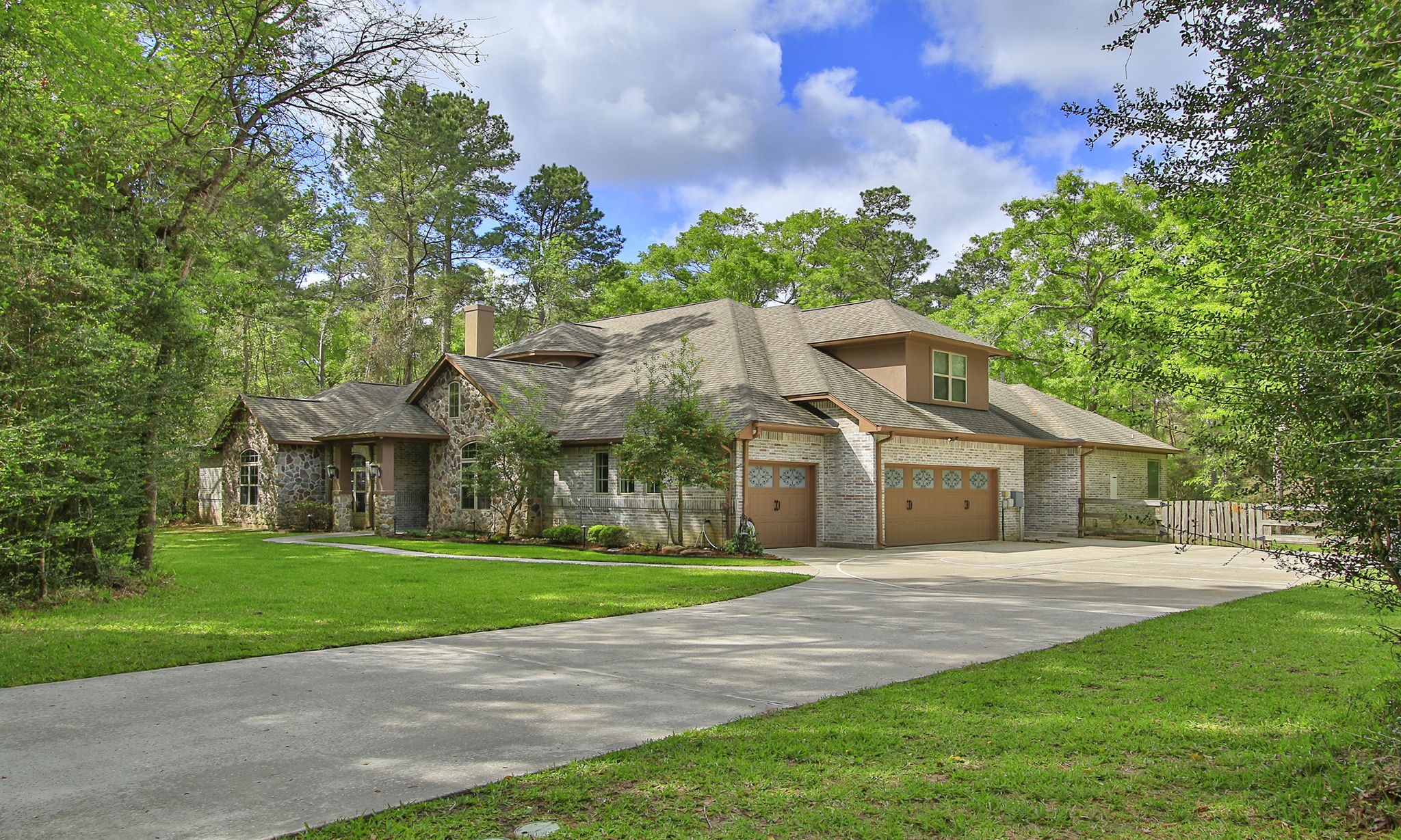 28007 Hickory Court Magnolia, TX 77355 - Photo 1 of 49 a front view of a house with a garden and trees