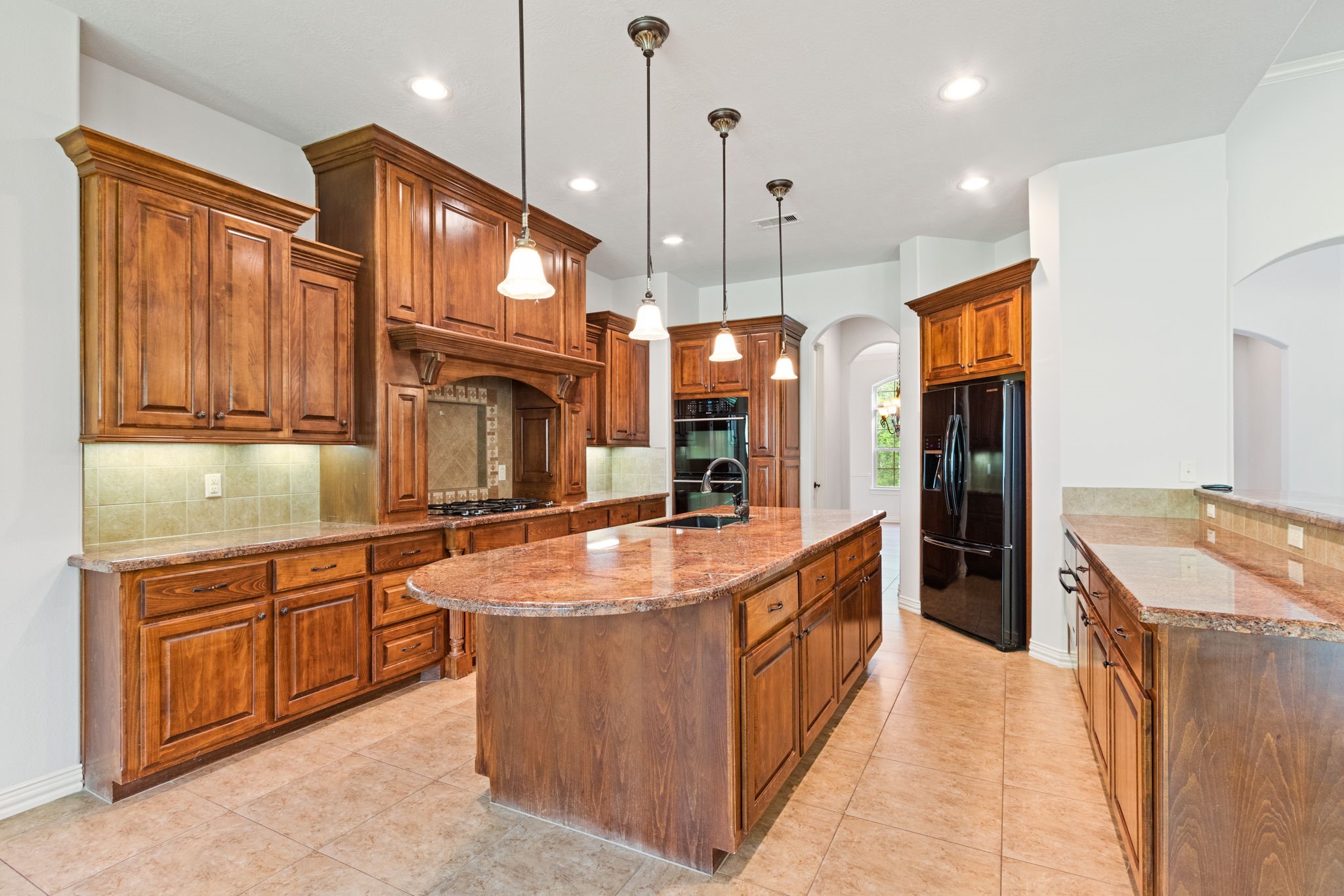 28007 Hickory Court Magnolia, TX 77355 - Photo 15 of 49 a large kitchen with kitchen island a large counter top stainless steel appliances and cabinets
