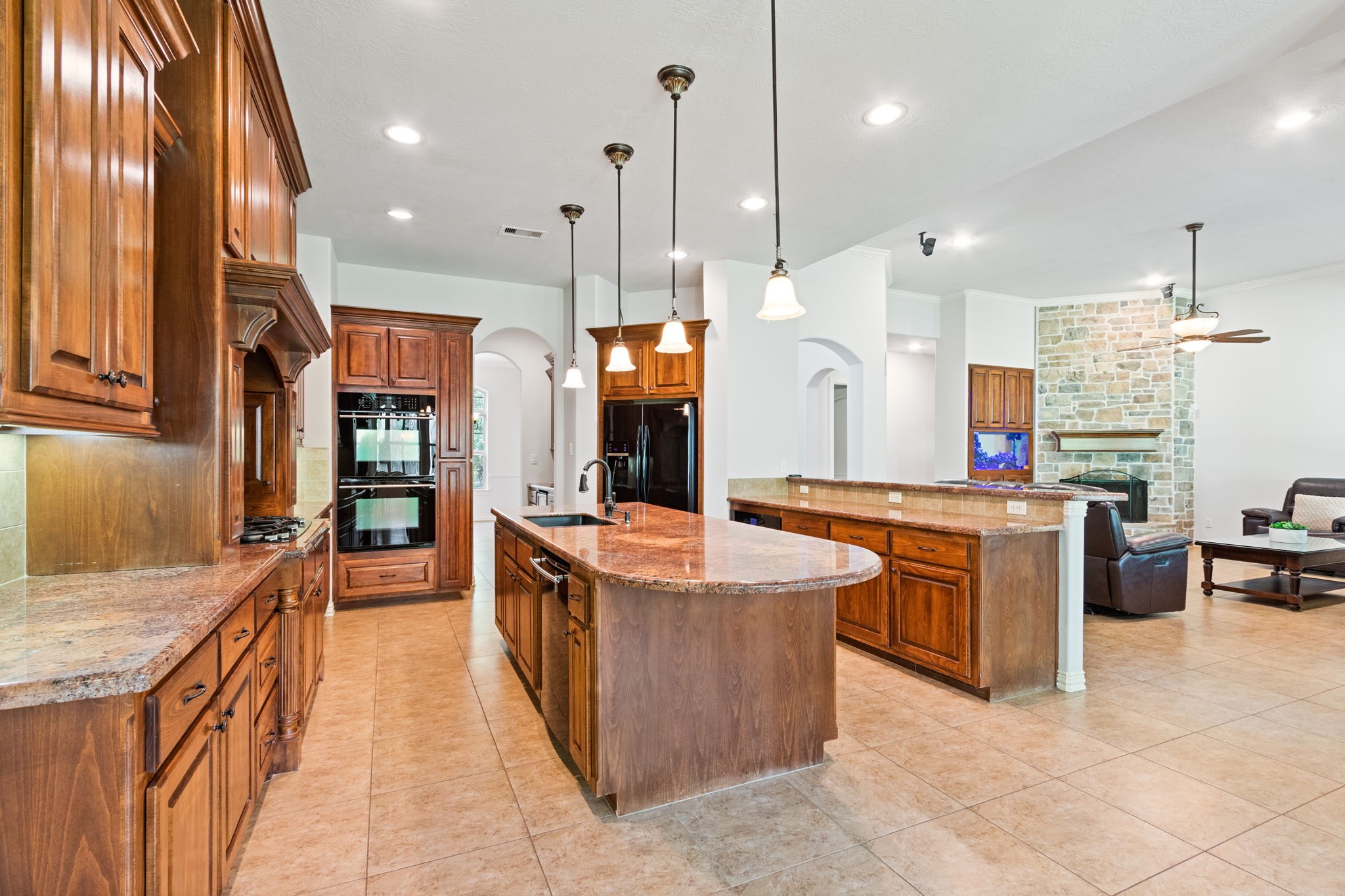 28007 Hickory Court Magnolia, TX 77355 - Photo 16 of 49 a large kitchen with stainless steel appliances kitchen island granite countertop a stove and a sink