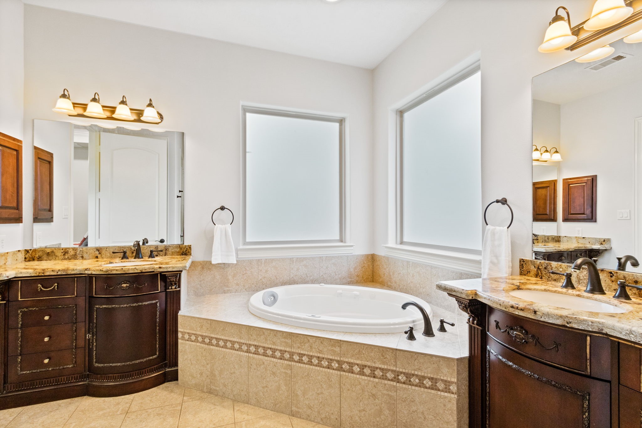 28007 Hickory Court Magnolia, TX 77355 - Photo 22 of 49 a bathroom with a granite countertop tub sink and mirror