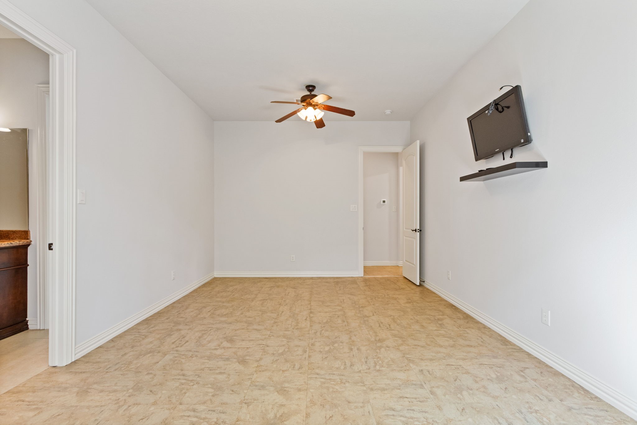 28007 Hickory Court Magnolia, TX 77355 - Photo 28 of 49 an empty room with ceiling fan and wooden floor