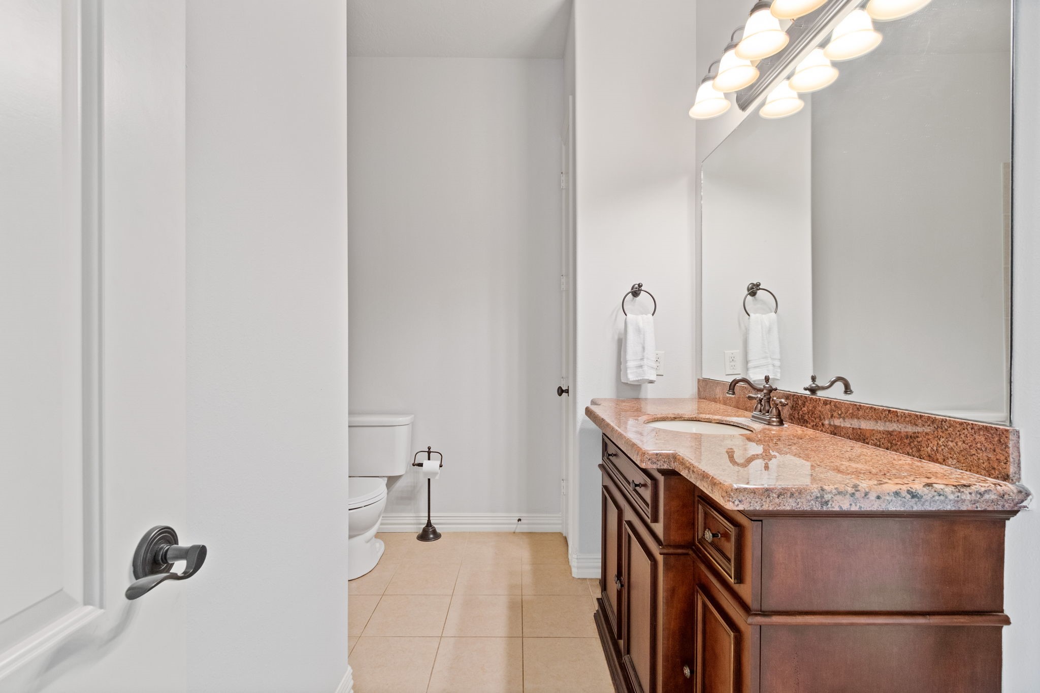 28007 Hickory Court Magnolia, TX 77355 - Photo 29 of 49 a bathroom with a sink vanity granite and a mirror