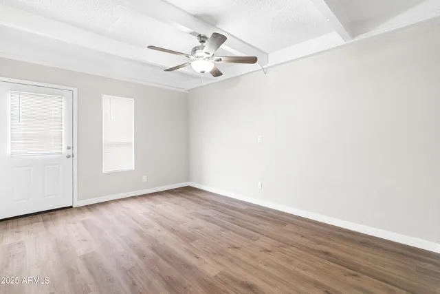 a kitchen with granite countertop white cabinets and white appliances