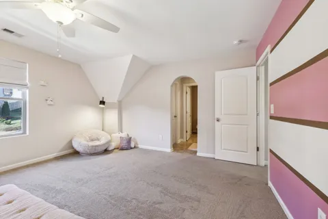 a bedroom with a bed and a lamp