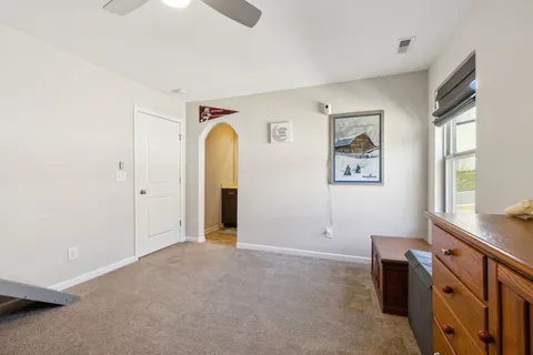 a bathroom with a granite countertop sink toilet and a mirror