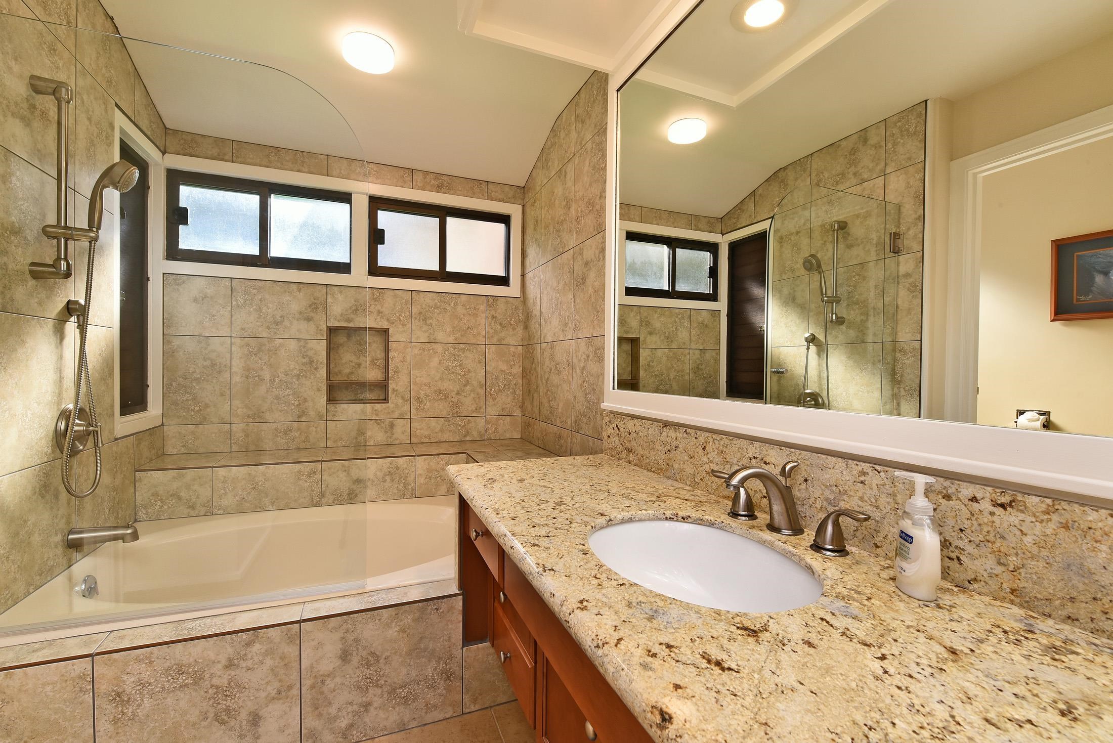 100 Ridge Road, Unit 101315 Lahaina, HI 96761 - Photo 21 of 23 a bathroom with a granite countertop tub sink double vanity and mirror