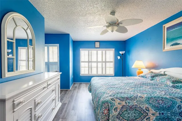 a bedroom with a large bed and a chandelier