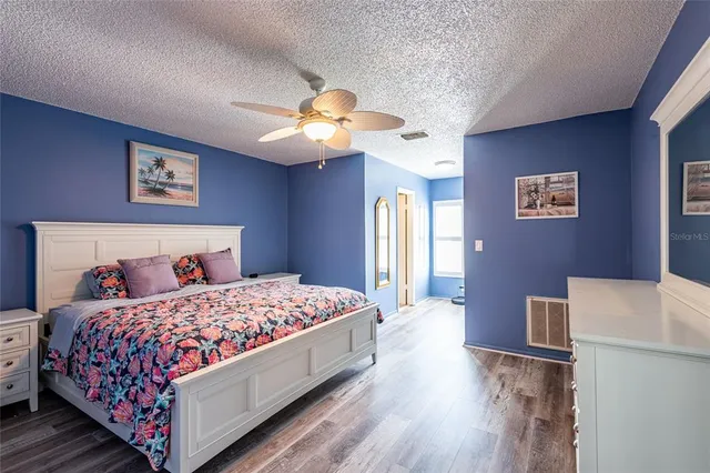 a bedroom with a large bed and a chandelier