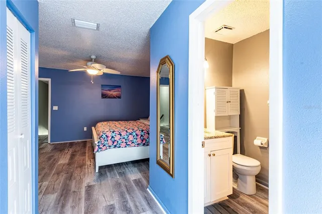 a bathroom with a toilet sink a mirror and shower