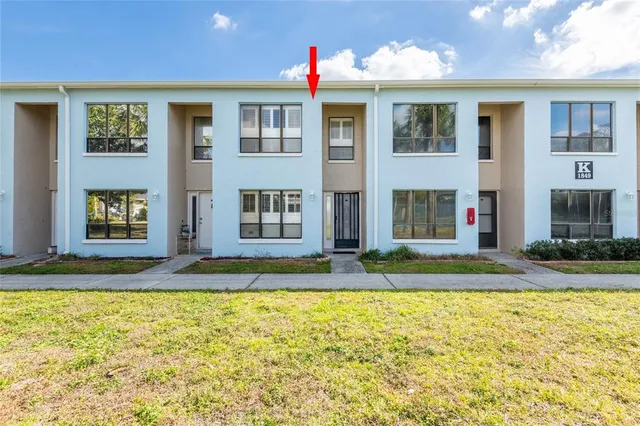 a view of a brick house with a yard