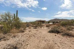 a view of a dry yard covered with snow in back