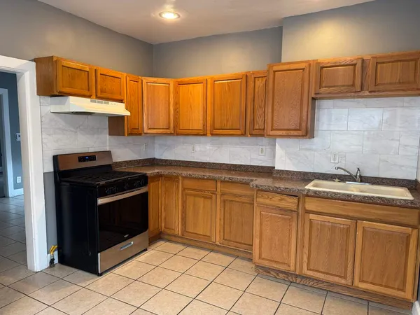 a kitchen with stainless steel appliances granite countertop a sink stove and cabinets