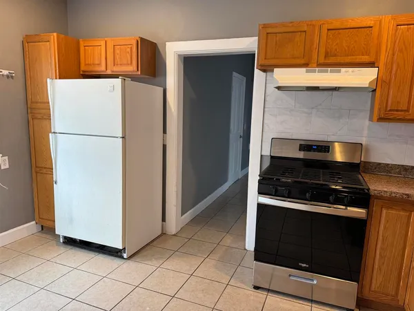 a kitchen with granite countertop cabinets and steel stainless steel appliances
