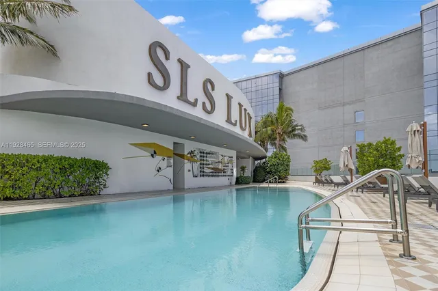 a living room with furniture pool table and a flat screen tv