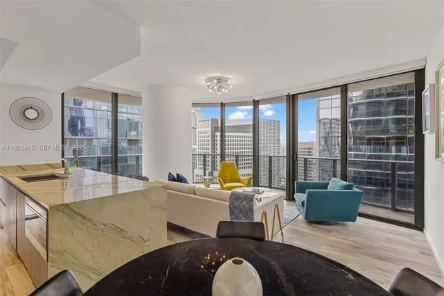 a living room with furniture and large windows