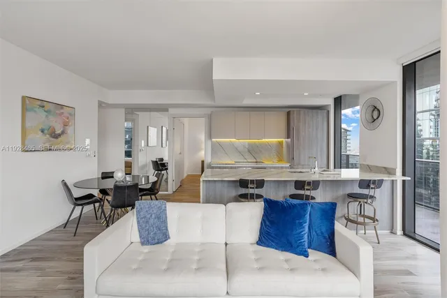 a kitchen with a stove a table and chairs in it