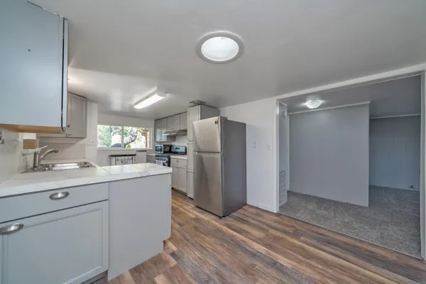 a kitchen with a refrigerator sink and cabinets