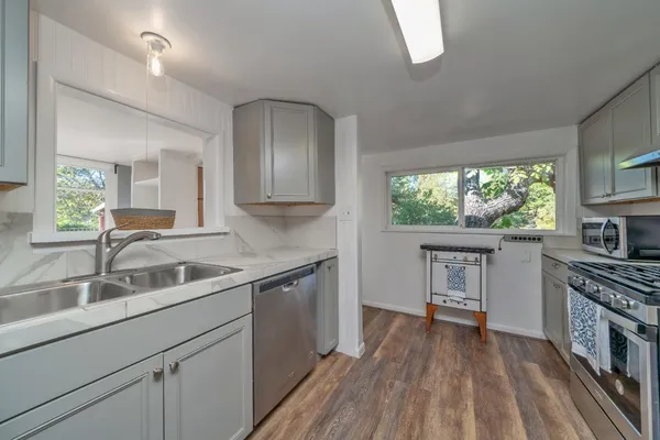a kitchen with a sink stove and cabinets